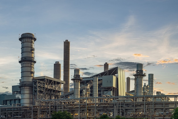 a factory with smokestacks and pipes